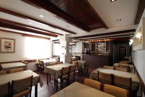 a restaurant with tables and chairs in a room at Hotel Bella Vista in Budva