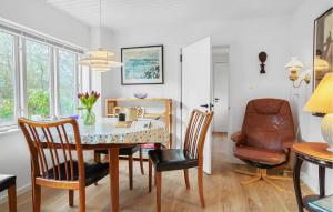 a dining room with a table and chairs at Nice Home In Samsø With Wifi in Ballen