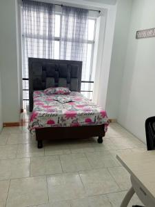 a bedroom with a bed in a room with windows at Texworks Coliving in Cali