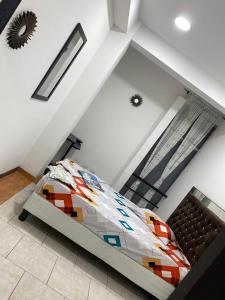 a bedroom with a bed in a loft at Texworks Coliving in Cali
