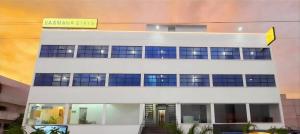 a building with a sign on top of it at Hotel VAAMANA STAYS in Tirupati