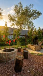 a garden with a fire pit and three logs at Valley homestay Dalat in Da Thien