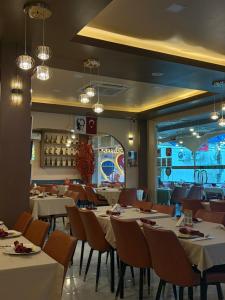 a dining room with white tables and chairs at Kiwi Boutique Hotel in Patong Beach +24 photos