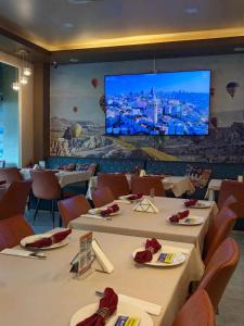 a conference room with tables and a large screen at Kiwi Boutique Hotel in Patong Beach