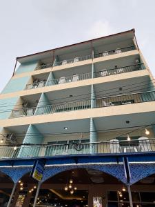 a tall building with balconies on the side of it at Kiwi Boutique Hotel in Patong Beach