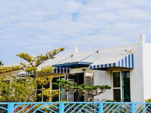 a house with a blue fence in front of it at 好室行旅House inn 金門大學旁 近市區 in Jinning +31 photos
