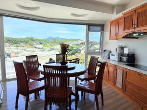 a kitchen with a table and chairs and a large window at Starview Villa Dalat in Da Lat