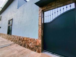 a blue garage door on a white building at Casa Kanaph Reynosa 1 in Reynosa