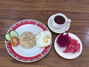 a plate of breakfast food with a cup of coffee at Ojek's Homestay in Ubud