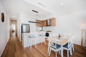 a kitchen and dining room with a table and chairs at Hello Dolphins Villas in Mandurah