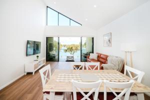 a living room with a table and chairs at Hello Dolphins Villas in Mandurah