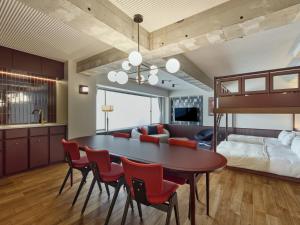 a living room with a dining room table and a bed at illi Tex Aoyama in Tokyo