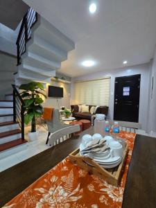 a living room with a table with plates on it at J Spazio Apartelle and Cafe in Baranghauon
