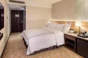 Postel nebo postele na pokoji v ubytování K Hotel Tianjin