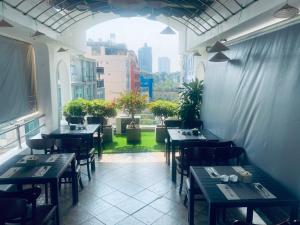 a restaurant with tables and chairs and a window at Sono Sallute Luxury Hotel in Ho Chi Minh City