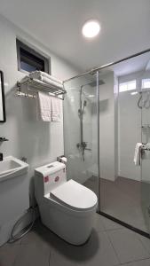 a white bathroom with a toilet and a shower at Sono Sallute Luxury Hotel in Ho Chi Minh City +40 photos