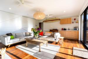 a living room with a couch and a table at Toi Toi Apartment in Martinborough