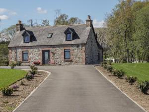 a driveway leading to a stone house at Nanville in Beauly