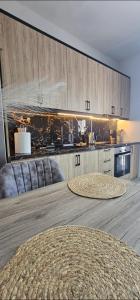 a kitchen with wooden cabinets and a large wooden table at Alma-Librehouse in Kefalos