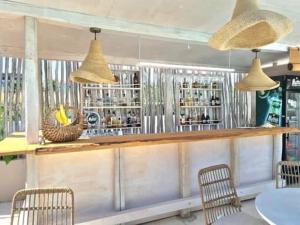 a restaurant with a bar with chairs and lights at Villa Olga Lounge Hotel in Lygia