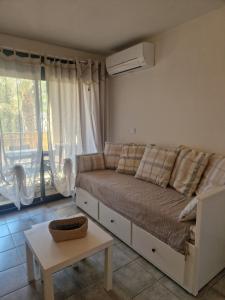 a living room with a couch and a table at Sanary Soleil et Douceur V in Sanary-sur-Mer +20 photos