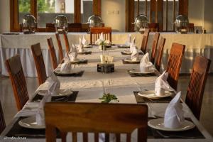 a long table with chairs and napkins on it at Hispar Hotel Skardu in Skardu
