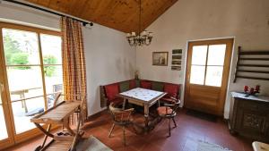 a dining room with a table and chairs and a window at Gartenidylle Melk in Melk +14 photos
