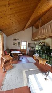 a living room with a wooden ceiling and a table at Gartenidylle Melk in Melk
