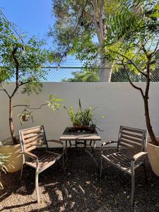 a patio with two chairs and a table with a plant at Vacation Villa Marina in Puerto Vallarta