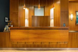 a wooden counter top in a room with at Vienna House by Wyndham Sonne Rostock in Rostock