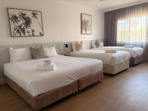 a hotel room with two beds and a window at The Quarters, an Ascend Collection Hotel in Wamberal +83 photos