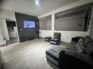 a living room with a couch and a tv at Casa KM222 in Esquipulas