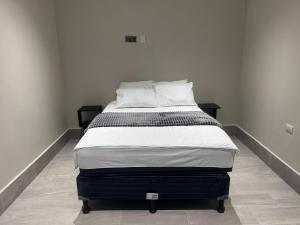 a bed sitting in a room with sidx sidx sidx at Casa KM222 in Esquipulas