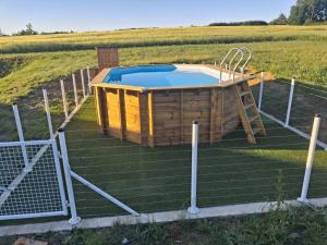 a hot tub in the middle of a field at maison de campagne rénovée avec piscine in Duras
