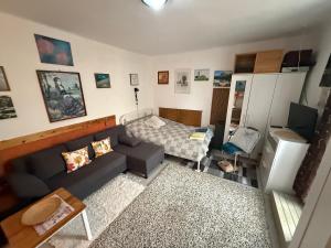 a living room with a couch and a bed at Levendula ház Vác in Vác