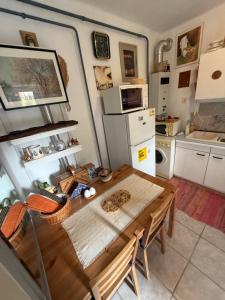 a kitchen with a wooden table in a room at Levendula ház Vác in Vác