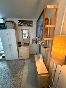 a room with a desk and a lamp and a mirror at Levendula ház Vác in Vác +7 photos