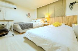 a room with two beds in a room at Hongdae 10 min Family 2BR Direct Airport Bus from ICN airport in Seoul