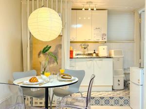 a kitchen and dining room with a table and chairs at Hongdae 10 min Family 2BR Direct Airport Bus from ICN airport in Seoul