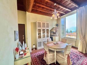 a dining room with a table and a large window at Antica Casa Fenaroli in Iseo