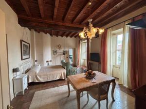 a bedroom with a bed and a table in a room at Antica Casa Fenaroli in Iseo