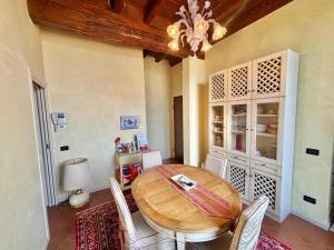 a dining room with a wooden table and chairs at Antica Casa Fenaroli in Iseo +9 photos