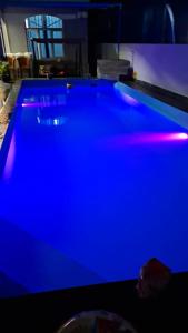a pool with blue lights in a living room at Blue Horizon Villa in Grand Baie in Grand-Baie