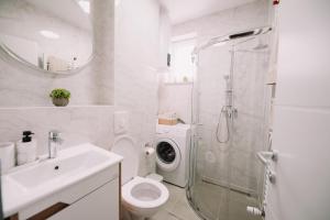 a bathroom with a toilet and a sink and a shower at KDolićiM in Livno