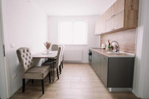 a kitchen with a table and chairs and a sink at KDolićiM in Livno