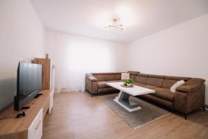 a living room with a couch and a tv at KDolićiM in Livno