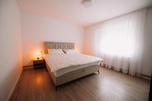 a bedroom with a large bed and a window at KDolićiM in Livno