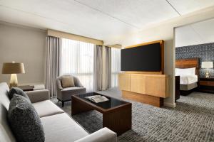 a hotel room with a couch and a television at DoubleTree by Hilton Pittsburgh-Green Tree in Pittsburgh