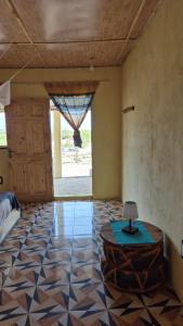 a room with a room with a table and a door at Terema Lodge in Kanuma