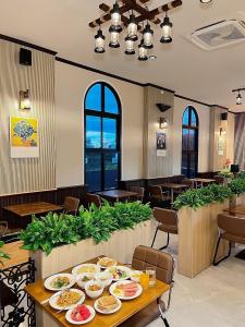 a restaurant with plates of food on a table at The Room Boutique Hotel in Sakon Nakhon